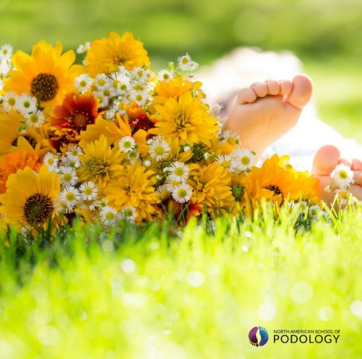 springtime bouquet with a person's feet showing on a field of grass