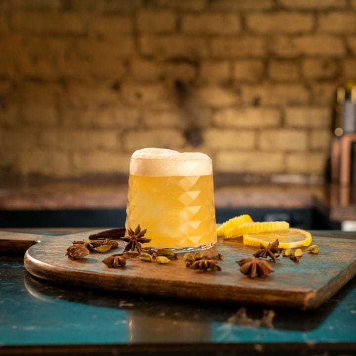 Tea House Sour cocktail on a cutting board